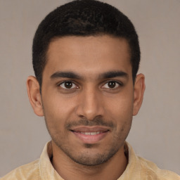 Joyful latino young-adult male with short  brown hair and brown eyes