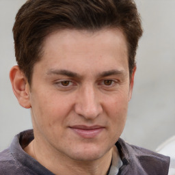 Joyful white adult male with short  brown hair and grey eyes