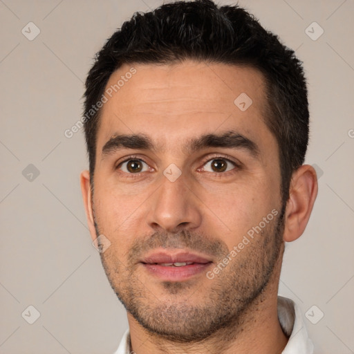 Joyful white young-adult male with short  black hair and brown eyes