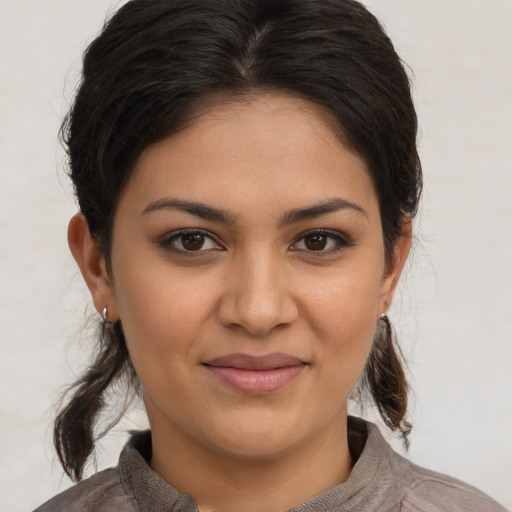 Joyful latino young-adult female with medium  brown hair and brown eyes