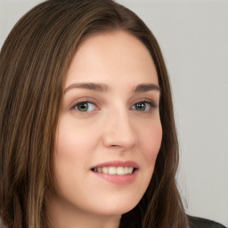 Joyful white young-adult female with long  brown hair and green eyes