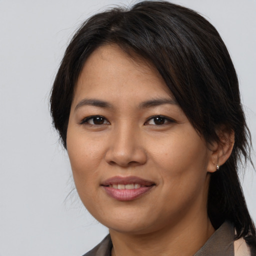 Joyful asian young-adult female with medium  brown hair and brown eyes