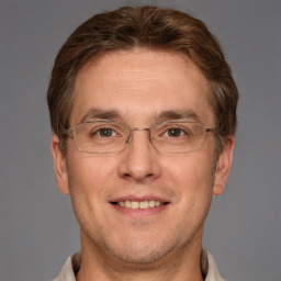 Joyful white adult male with short  brown hair and grey eyes