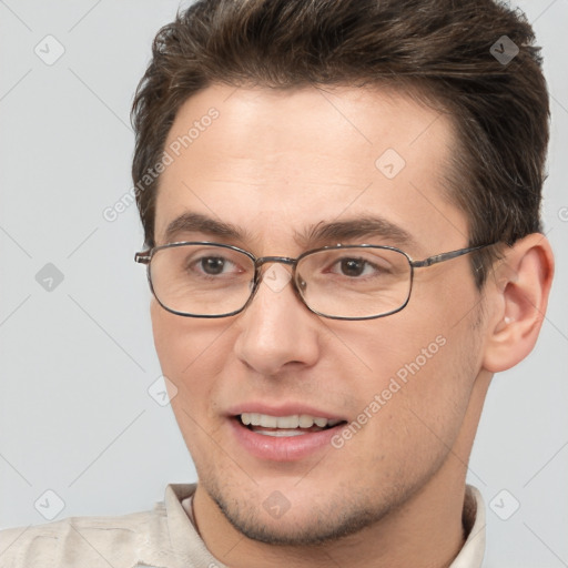 Joyful white adult male with short  brown hair and brown eyes