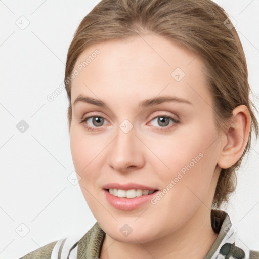 Joyful white young-adult female with medium  brown hair and blue eyes