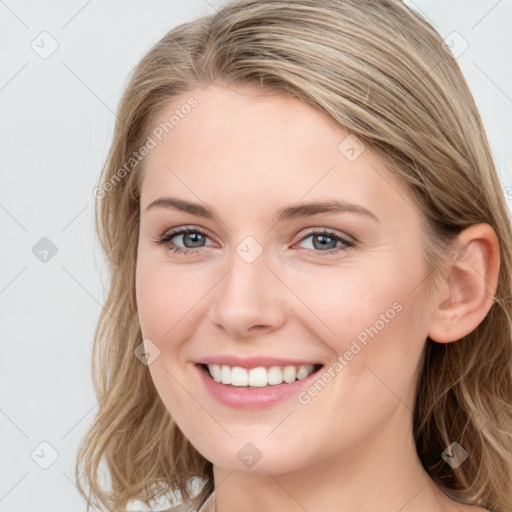 Joyful white young-adult female with long  brown hair and blue eyes