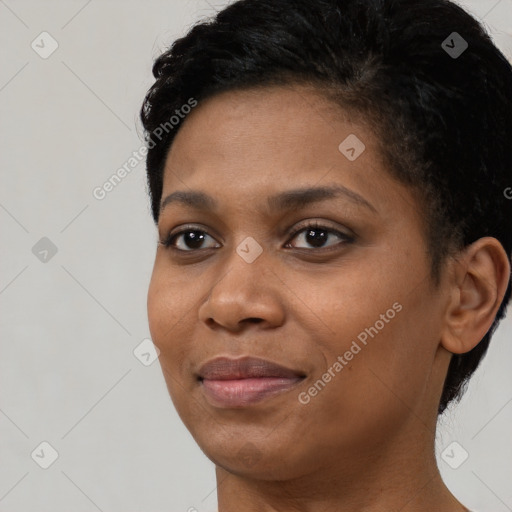 Joyful black young-adult female with short  black hair and brown eyes