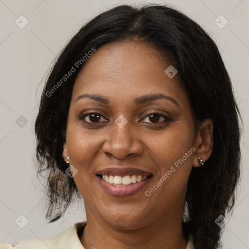 Joyful black adult female with medium  brown hair and brown eyes