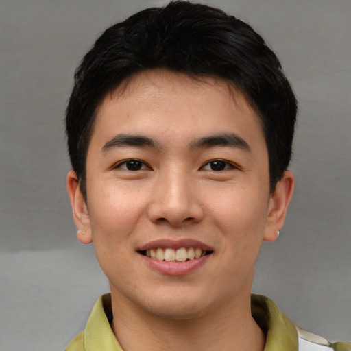 Joyful asian young-adult male with short  black hair and brown eyes