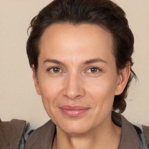 Joyful white adult female with medium  brown hair and brown eyes