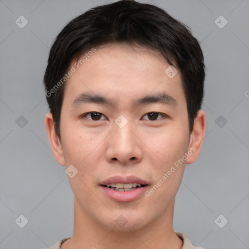 Joyful asian young-adult male with short  brown hair and brown eyes