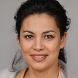 Joyful latino young-adult female with medium  brown hair and brown eyes