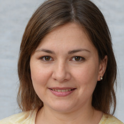 Joyful white young-adult female with medium  brown hair and brown eyes