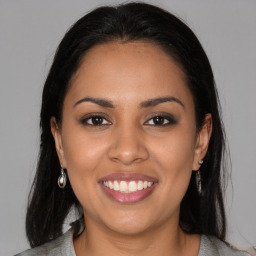 Joyful latino young-adult female with long  brown hair and brown eyes