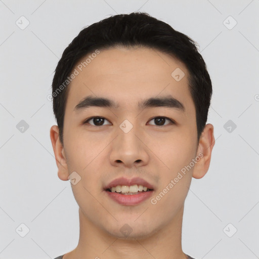 Joyful asian young-adult male with short  black hair and brown eyes