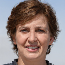 Joyful white adult female with medium  brown hair and brown eyes