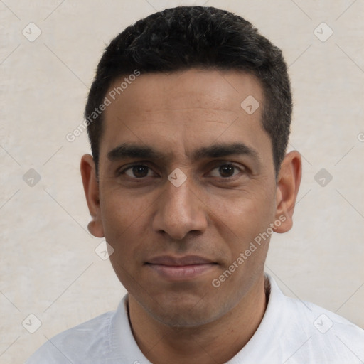 Joyful white adult male with short  black hair and brown eyes