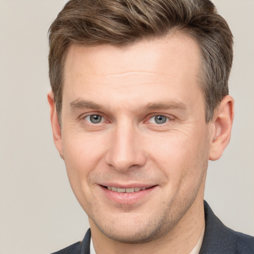 Joyful white adult male with short  brown hair and grey eyes