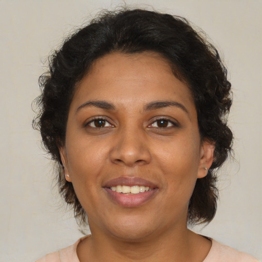 Joyful latino adult female with medium  brown hair and brown eyes