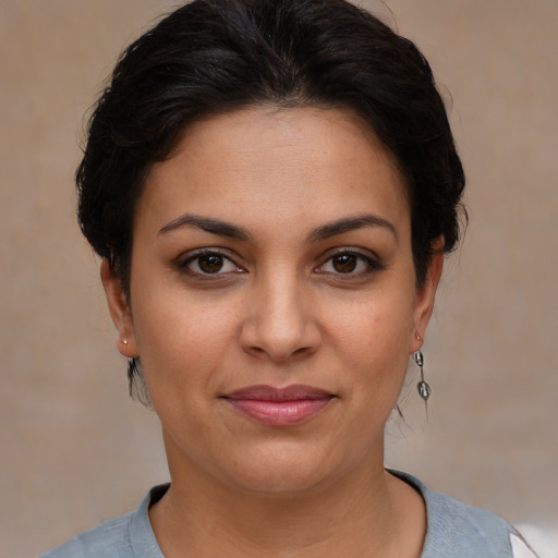 Joyful latino young-adult female with short  brown hair and brown eyes