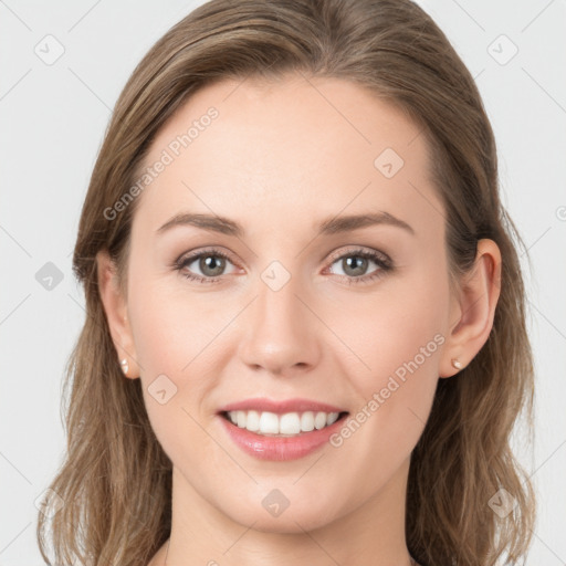 Joyful white young-adult female with long  brown hair and grey eyes