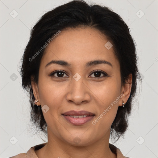 Joyful latino adult female with medium  brown hair and brown eyes