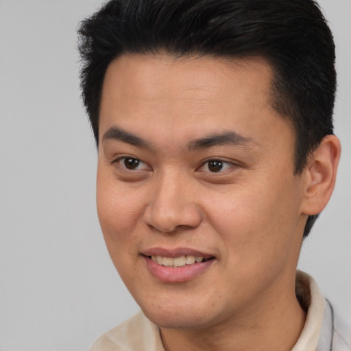 Joyful asian young-adult male with short  brown hair and brown eyes