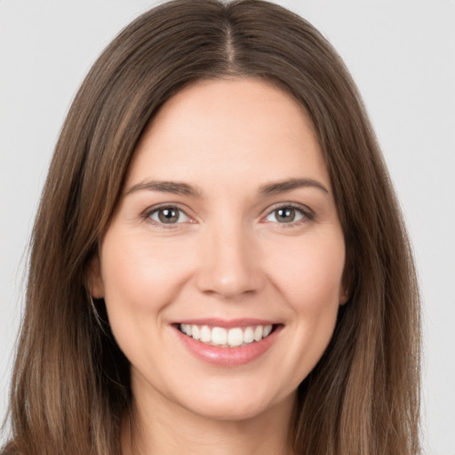 Joyful white young-adult female with long  brown hair and brown eyes