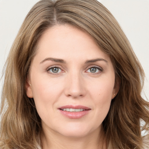 Joyful white young-adult female with long  brown hair and grey eyes