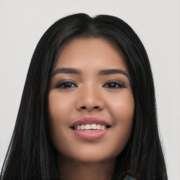 Joyful latino young-adult female with long  black hair and brown eyes