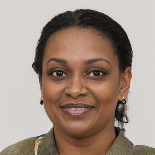 Joyful black adult female with short  black hair and brown eyes