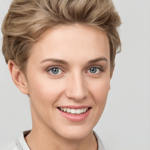 Joyful white young-adult female with short  brown hair and grey eyes