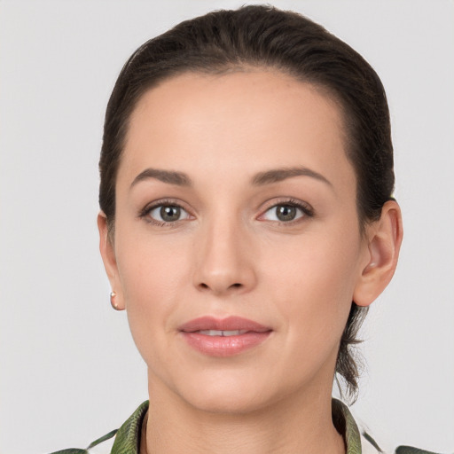 Joyful white young-adult female with medium  brown hair and brown eyes