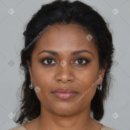 Joyful black young-adult female with long  brown hair and brown eyes
