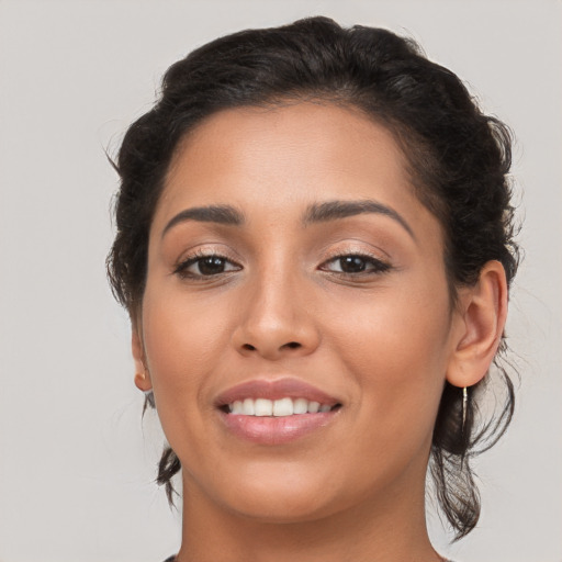 Joyful latino young-adult female with medium  brown hair and brown eyes