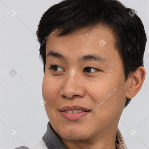 Joyful asian young-adult male with short  brown hair and brown eyes