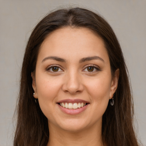 Joyful white young-adult female with long  brown hair and brown eyes