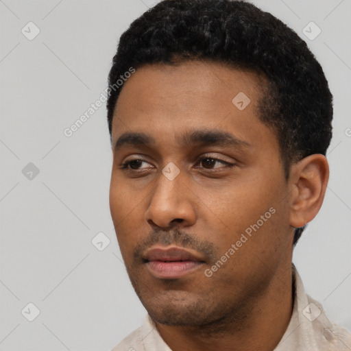 Neutral latino young-adult male with short  black hair and brown eyes