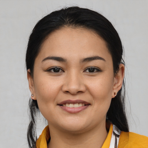 Joyful latino young-adult female with medium  black hair and brown eyes
