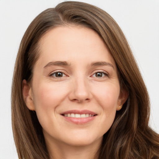 Joyful white young-adult female with long  brown hair and grey eyes