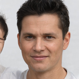 Joyful white adult male with short  brown hair and brown eyes