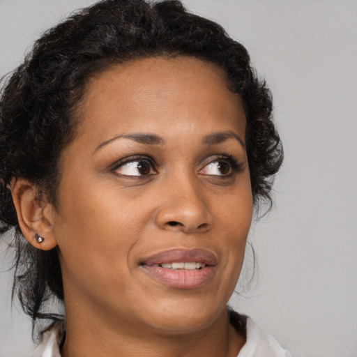 Joyful black young-adult female with medium  brown hair and brown eyes
