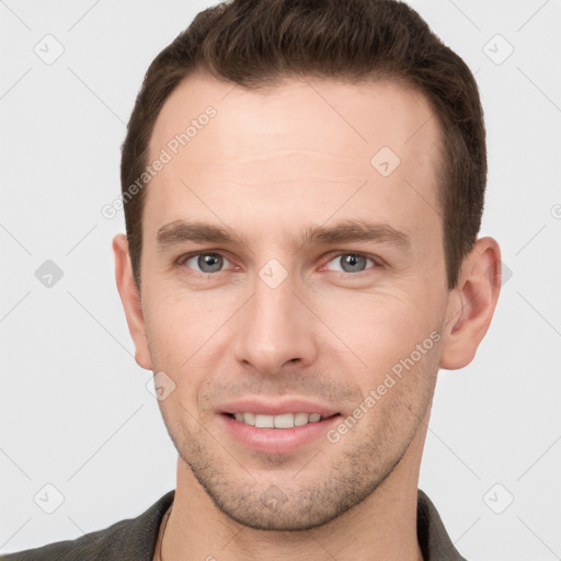 Joyful white young-adult male with short  brown hair and grey eyes