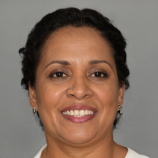 Joyful black adult female with short  brown hair and brown eyes