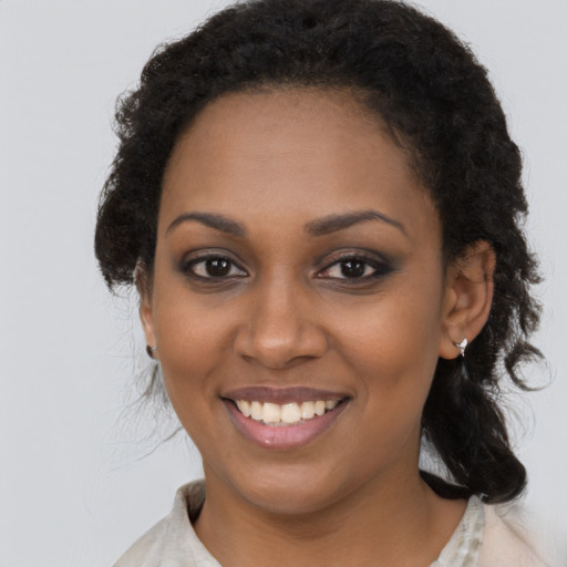 Joyful black young-adult female with medium  brown hair and brown eyes