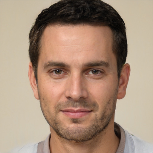 Joyful white young-adult male with short  brown hair and brown eyes