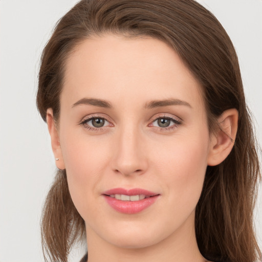 Joyful white young-adult female with long  brown hair and grey eyes