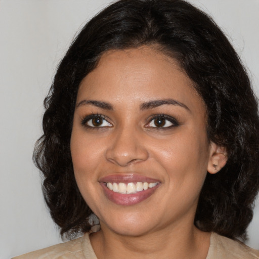 Joyful black young-adult female with medium  brown hair and brown eyes