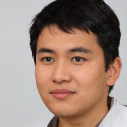 Joyful asian young-adult male with short  black hair and brown eyes