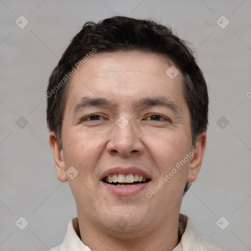 Joyful white adult male with short  brown hair and brown eyes